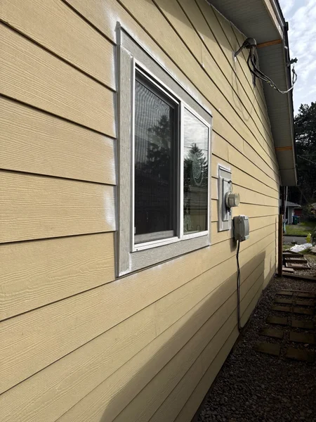 Exterior view of house with new siding installation and window